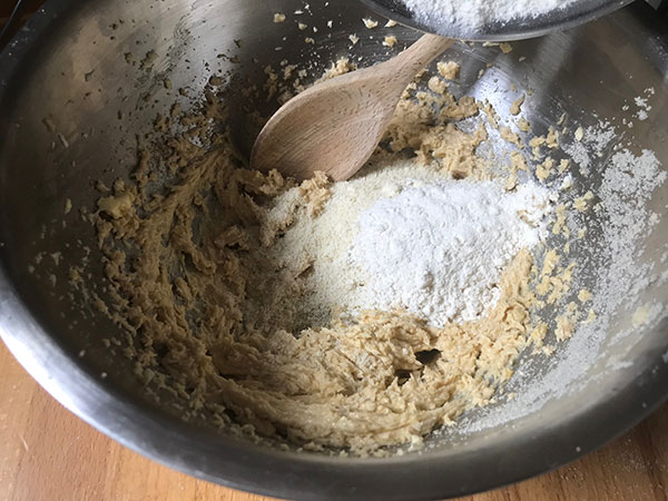 adding flour to bowl.